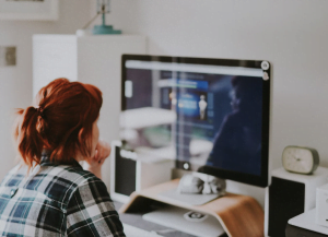 woman in casual clothes working on computer