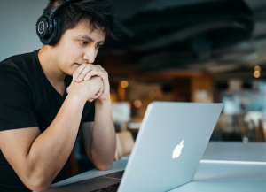 young man in black tshirt listening to important webinar on AWR