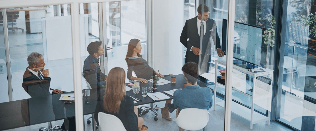 Image of people collaborating in a meeting within an office environment to illustrate post