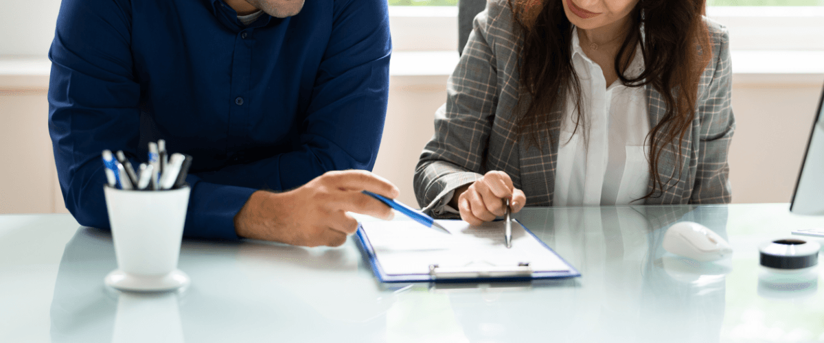 two people reviewing business terms